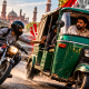 Rickshaw and motorcycles on a busy Pakistani road