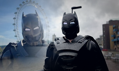 London's Batman wearing a black superhero costume near the River Thames after going viral for helping people through acts of kindness.