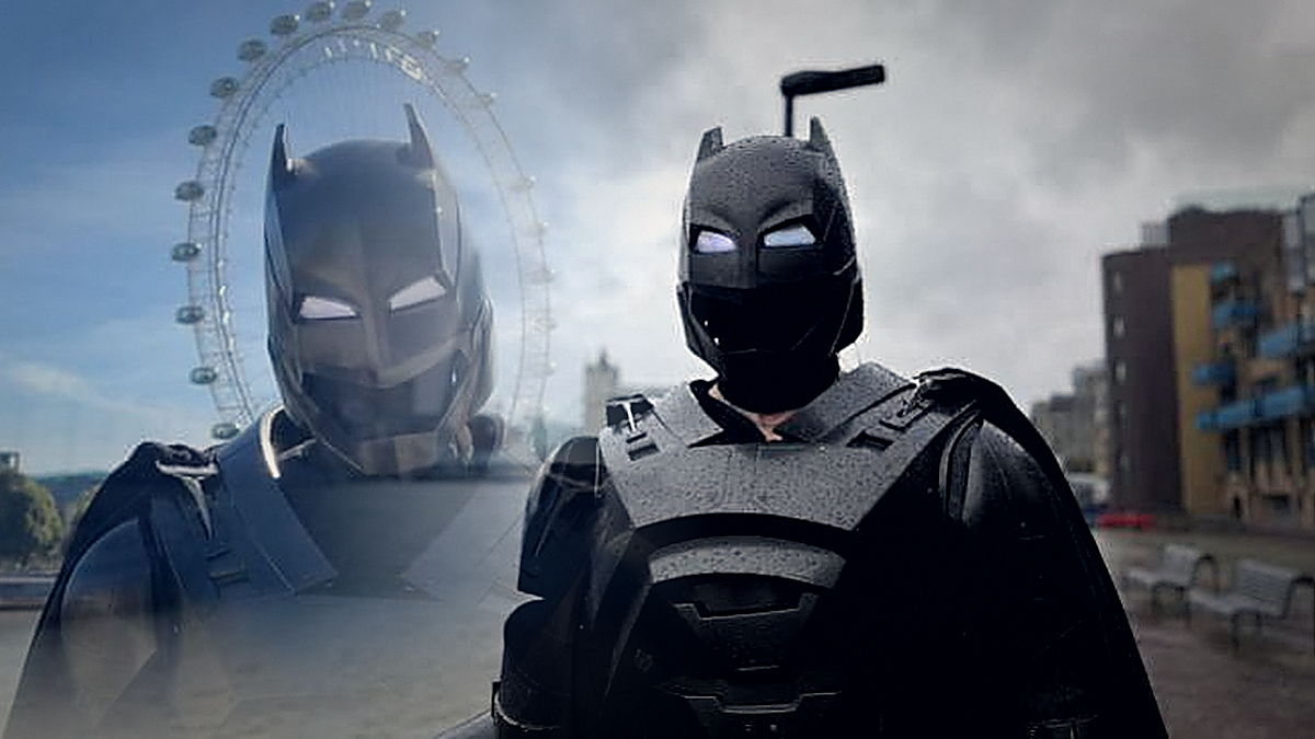 London's Batman wearing a black superhero costume near the River Thames after going viral for helping people through acts of kindness.